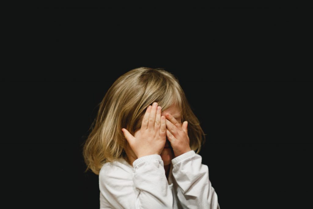 Girl resisting change by putting her hands over her eyes