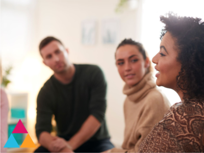 A group of people listening attentively as one person shares